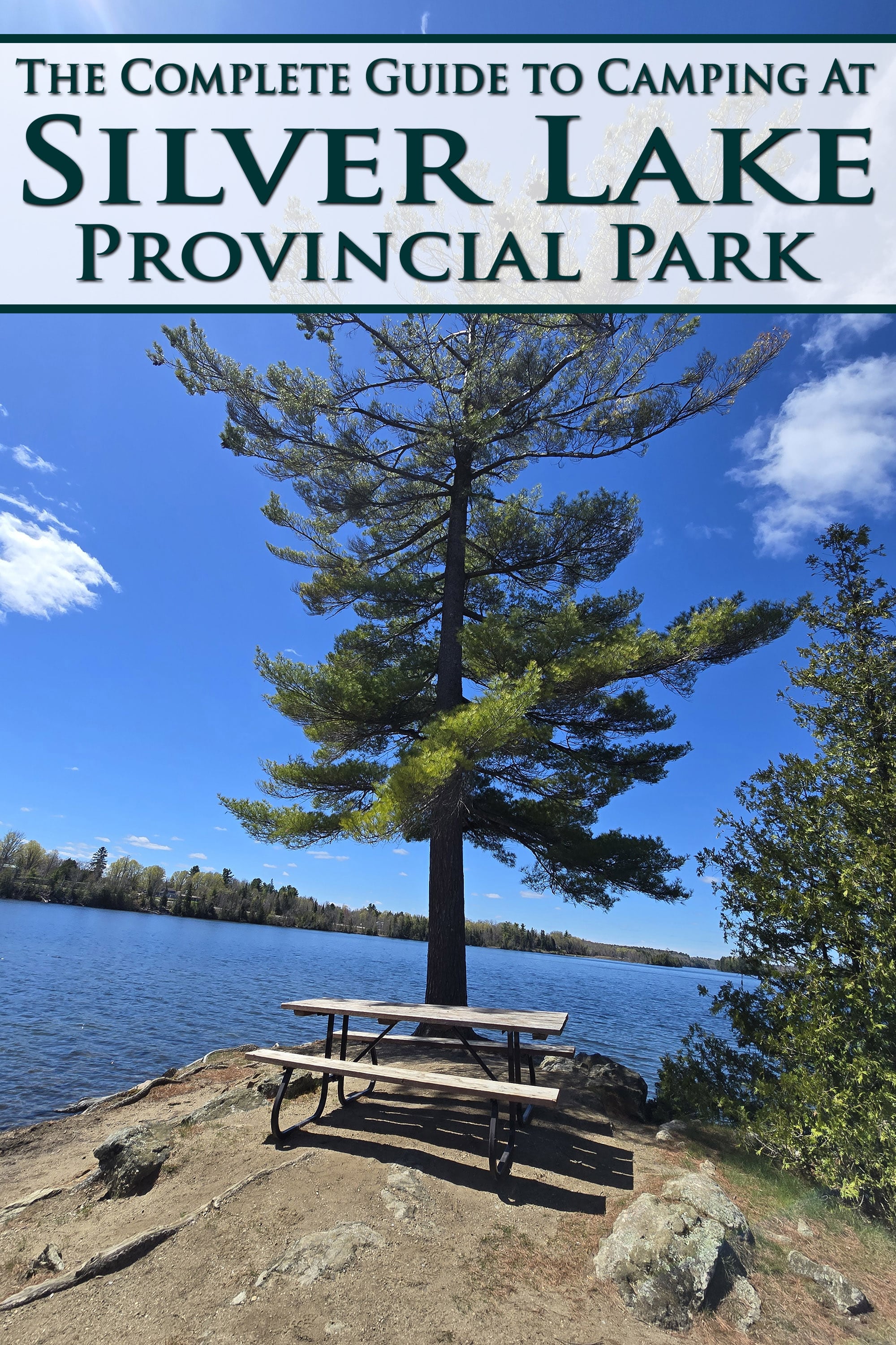 A picnic table on a small penisula overlooking a lake. Overlaid text says the complete camping guide to Silver Lake Provincial Park.