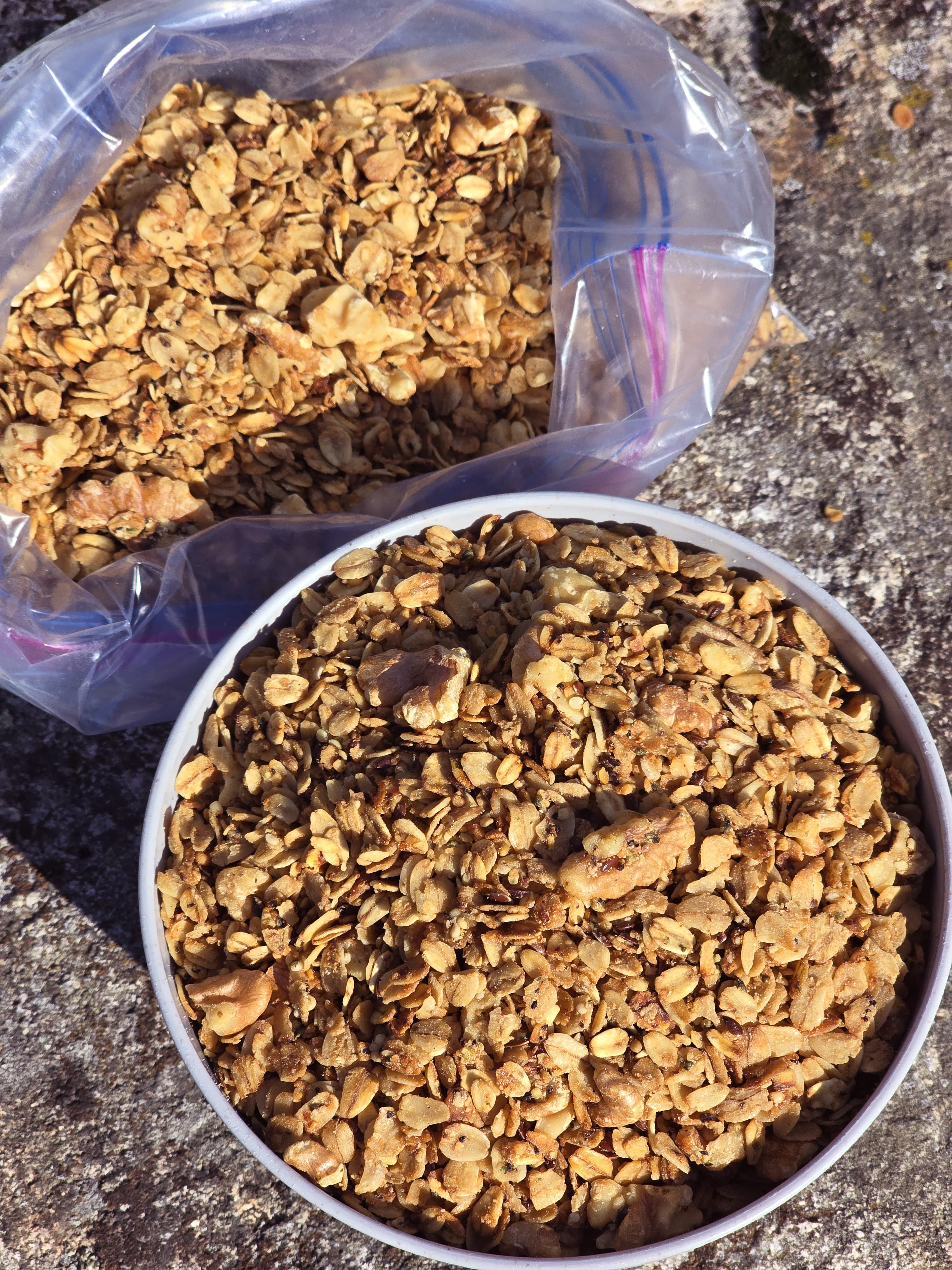 A bowl and a bag of homemade maple walnut granola.