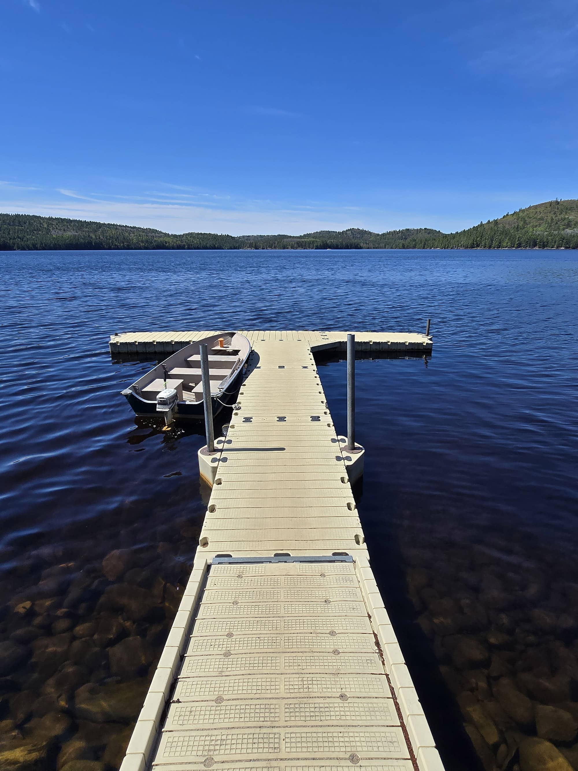A floating boat dock extending into Grand Lake.