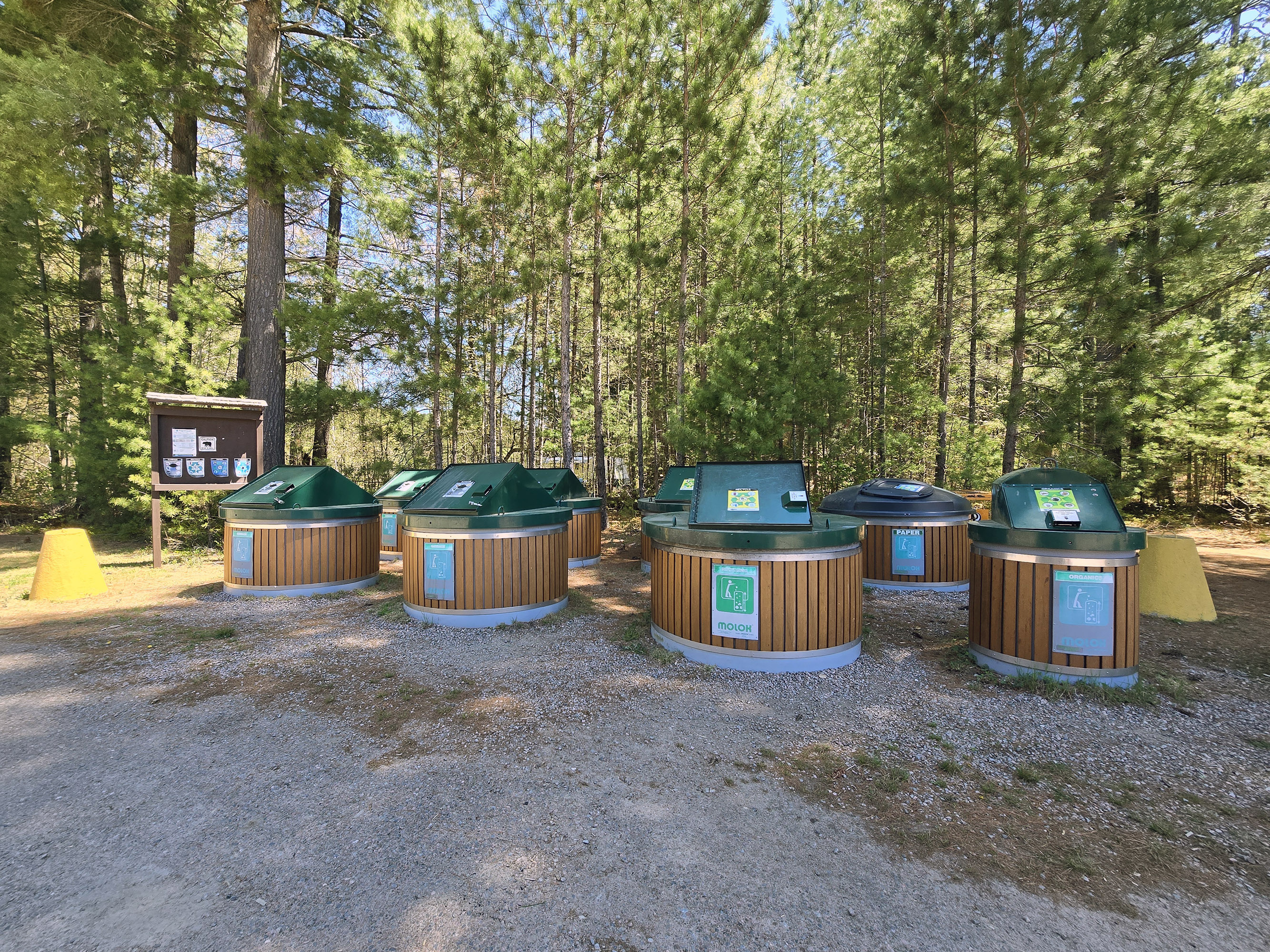 A set of large round garbage and recycling bins