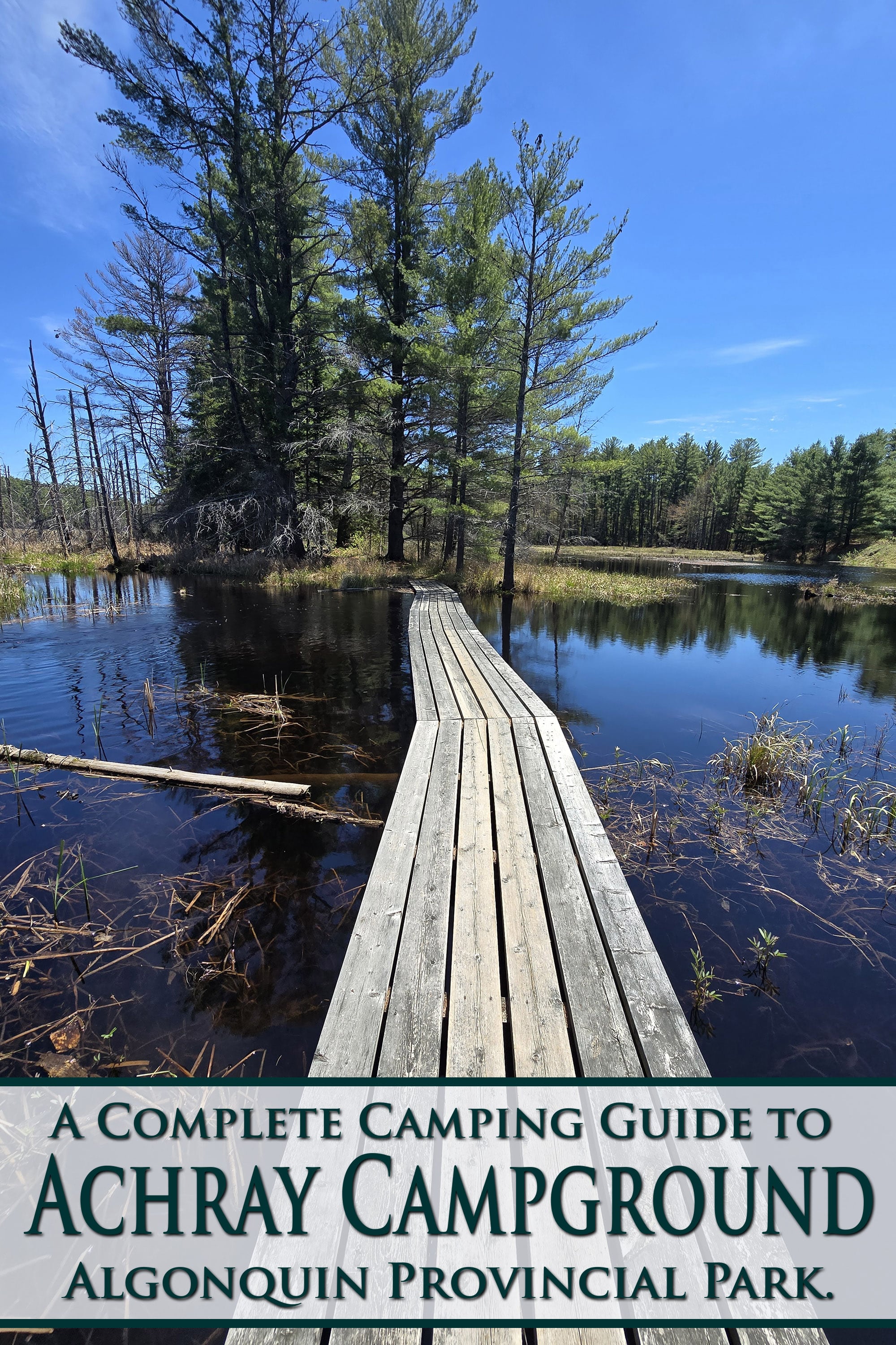 A narrow wooden bridge extending over a body of water. Overlaid text says a complete camping guide to Achray Campground, Algonquin Provincial Park.