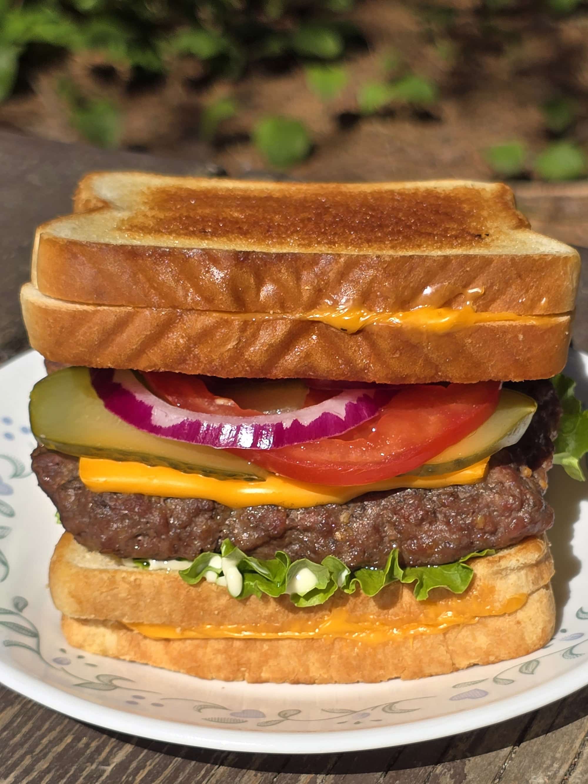 A loaded cheeseburger with grilled cheese sandwiches as the buns.