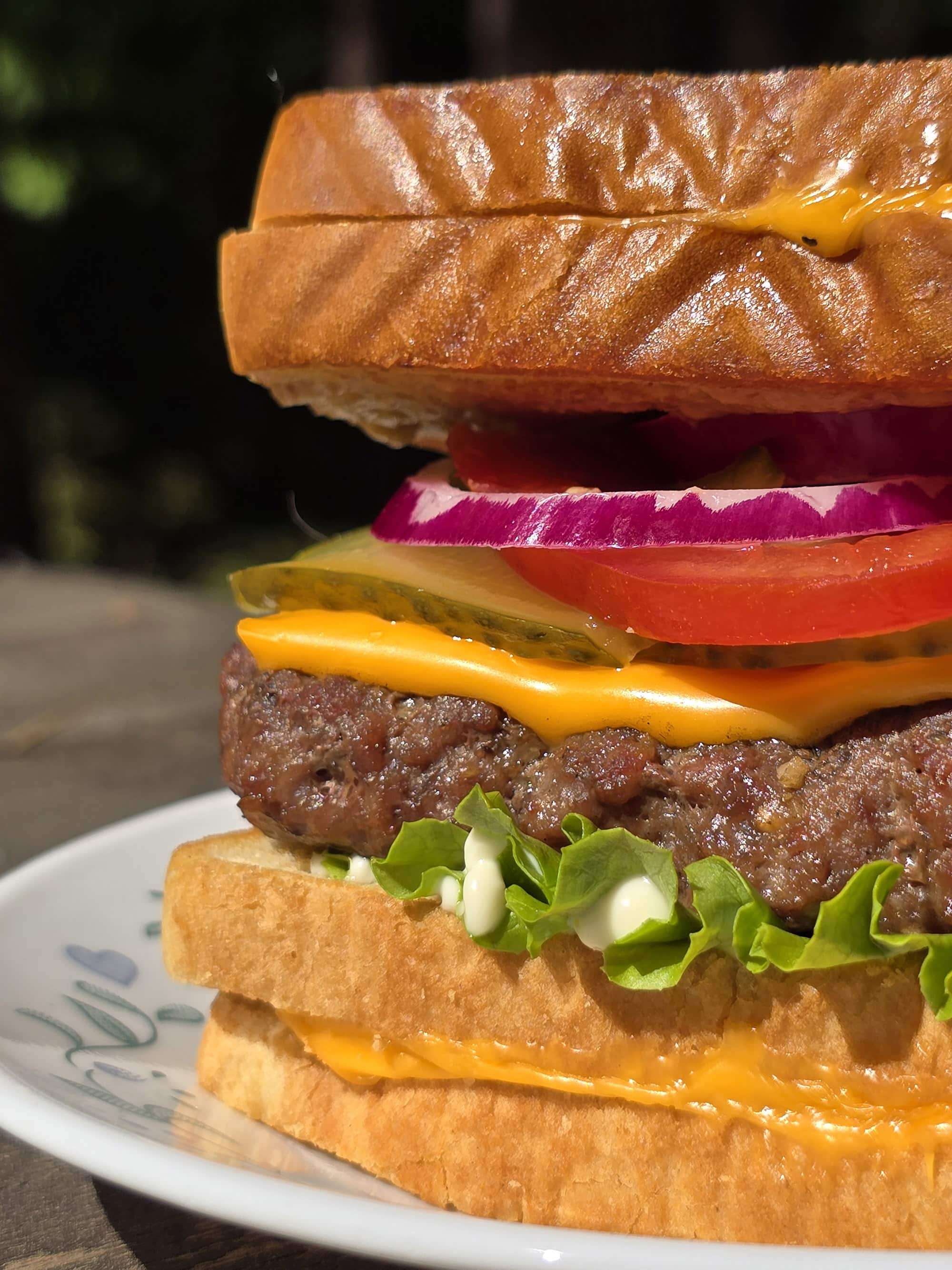 A grilled cheese cheeseburger made with a burger patty ad 2 grilled cheese sandwiches.