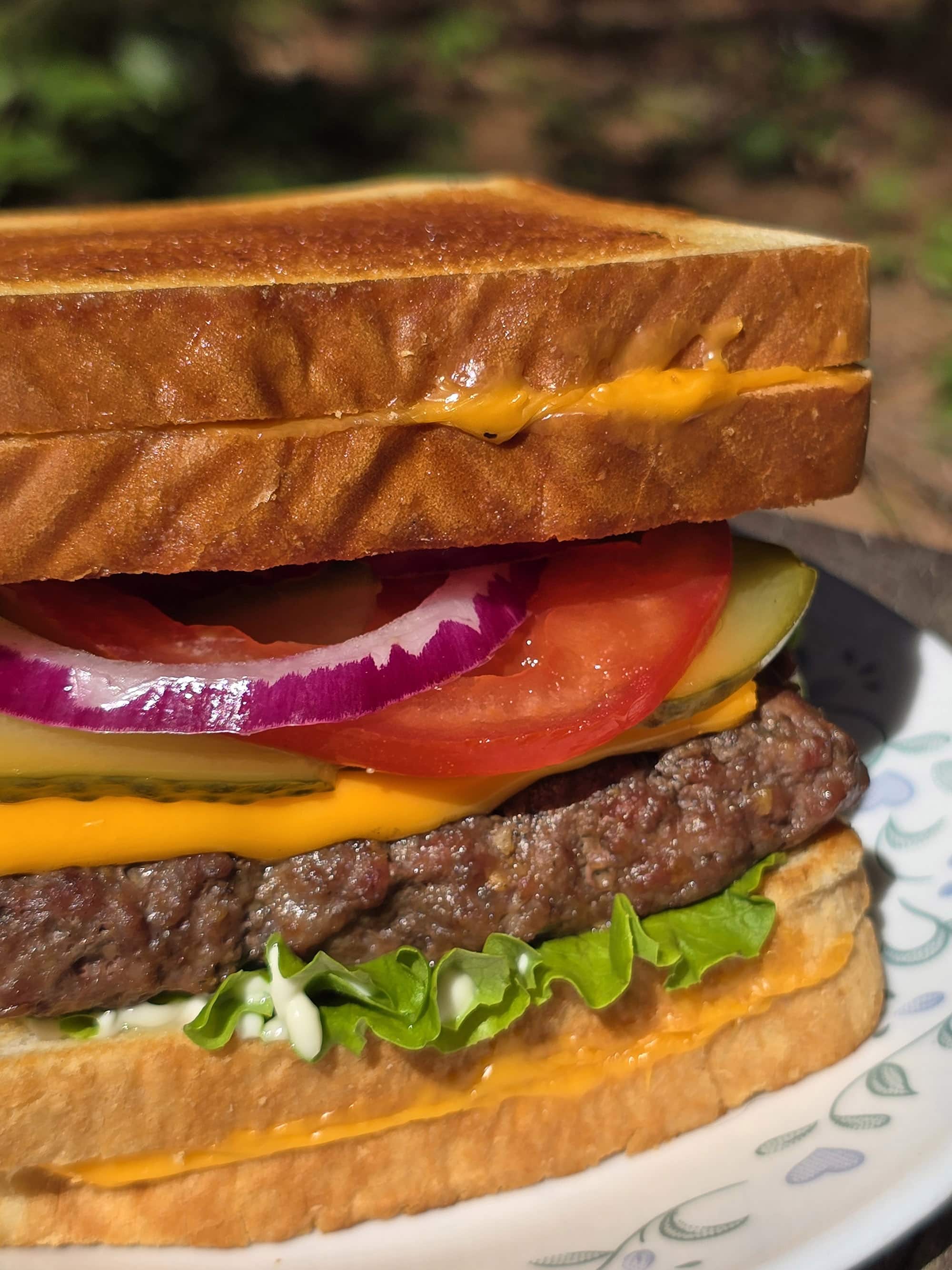 A loaded cheeseburger with grilled cheese sandwiches as the buns.