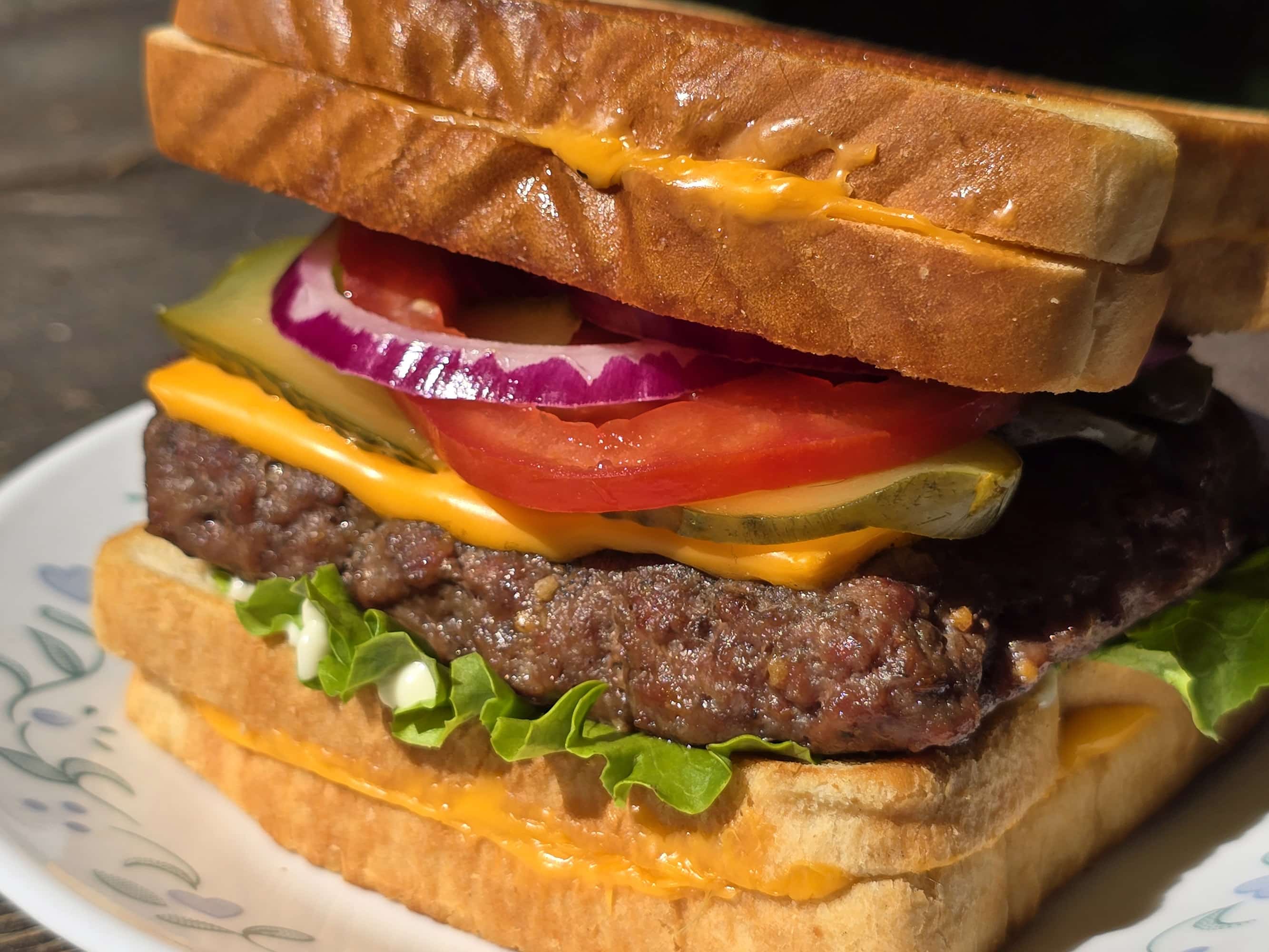 A loaded cheeseburger with grilled cheese sandwiches as the buns.