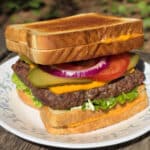 A grilled cheese cheeseburger made with a burger patty ad 2 grilled cheese sandwiches.