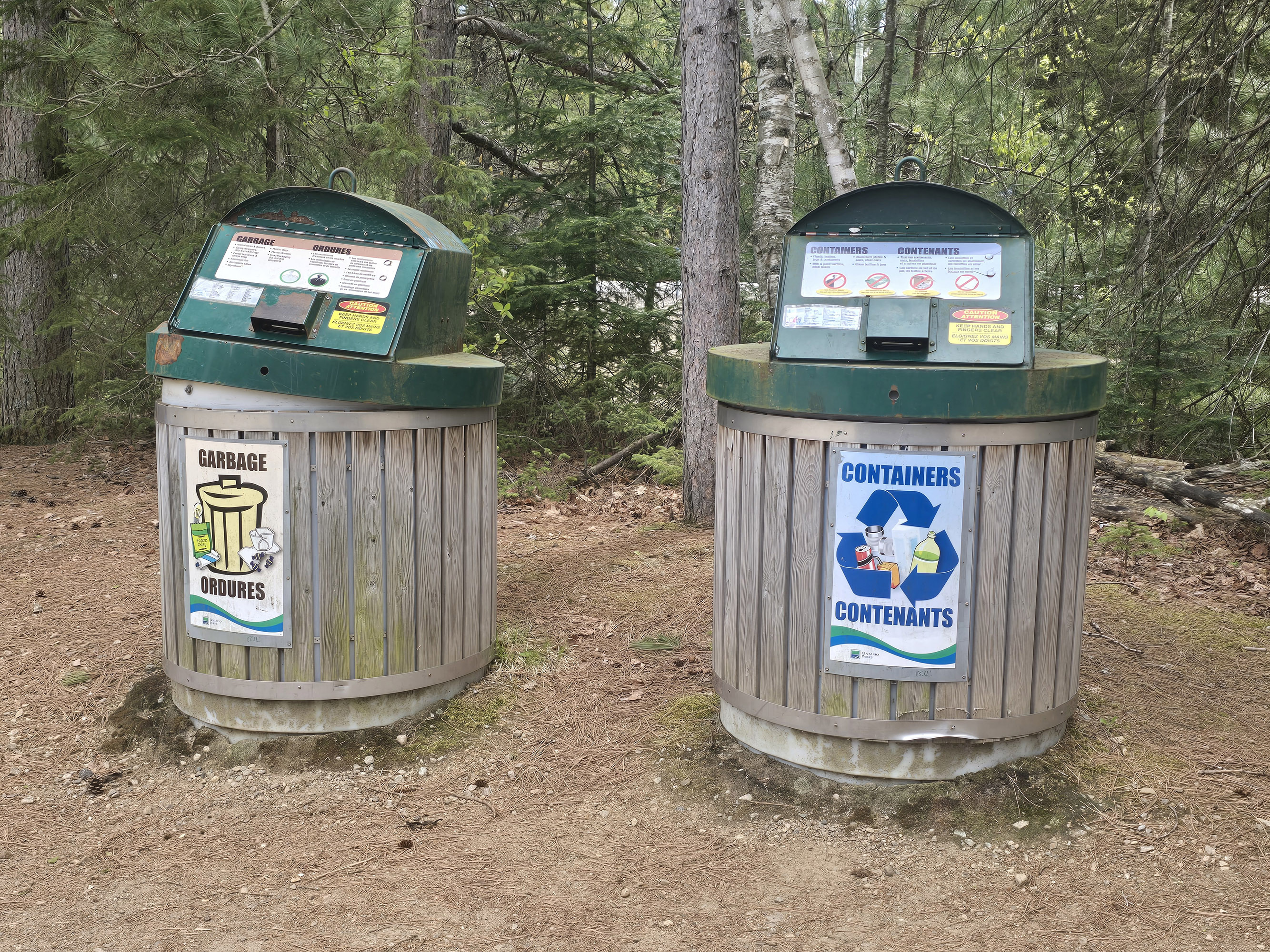 2 garbage cans at the Spruce Bog Boardwalk Trail in Algonquin Provincial Park.
